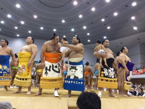 Wrestlers holding babies and young children in the ring