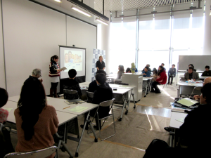 Anna Thomas and Amanda Wayama (in her country’s traditional clothing) giving a talk on the ILC